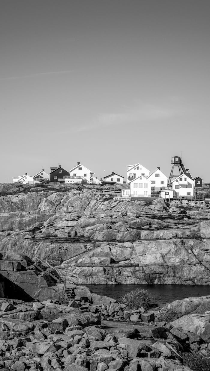 about-us-02 A picturesque view of Smögens rocky landscape and traditional houses captured in black and white.